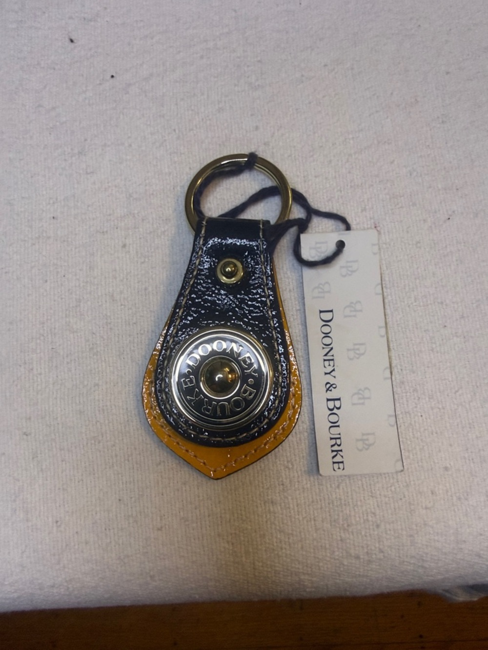 Dooney & Bourke Black and Mustard Leather Keychain with Brass Snap